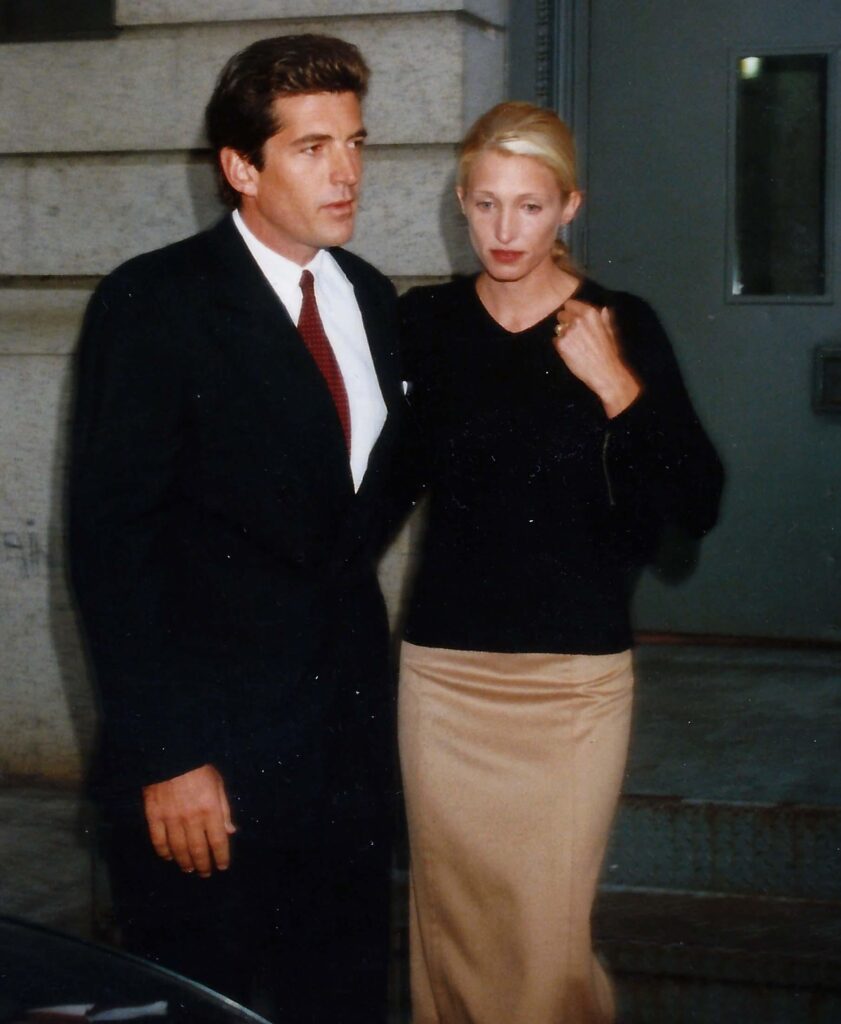 Carolyn Bessette Kennedy style with John F. Kennedy Jr., featuring her iconic minimalist fashion and neutral-toned outfit