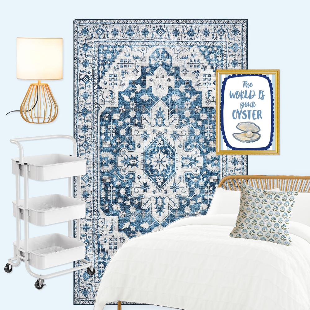 Affordable dorm room setup with blue patterned rug, white ruffled bedding, rolling cart bedside table, gold lamp, framed wall art, and blue block print pillow