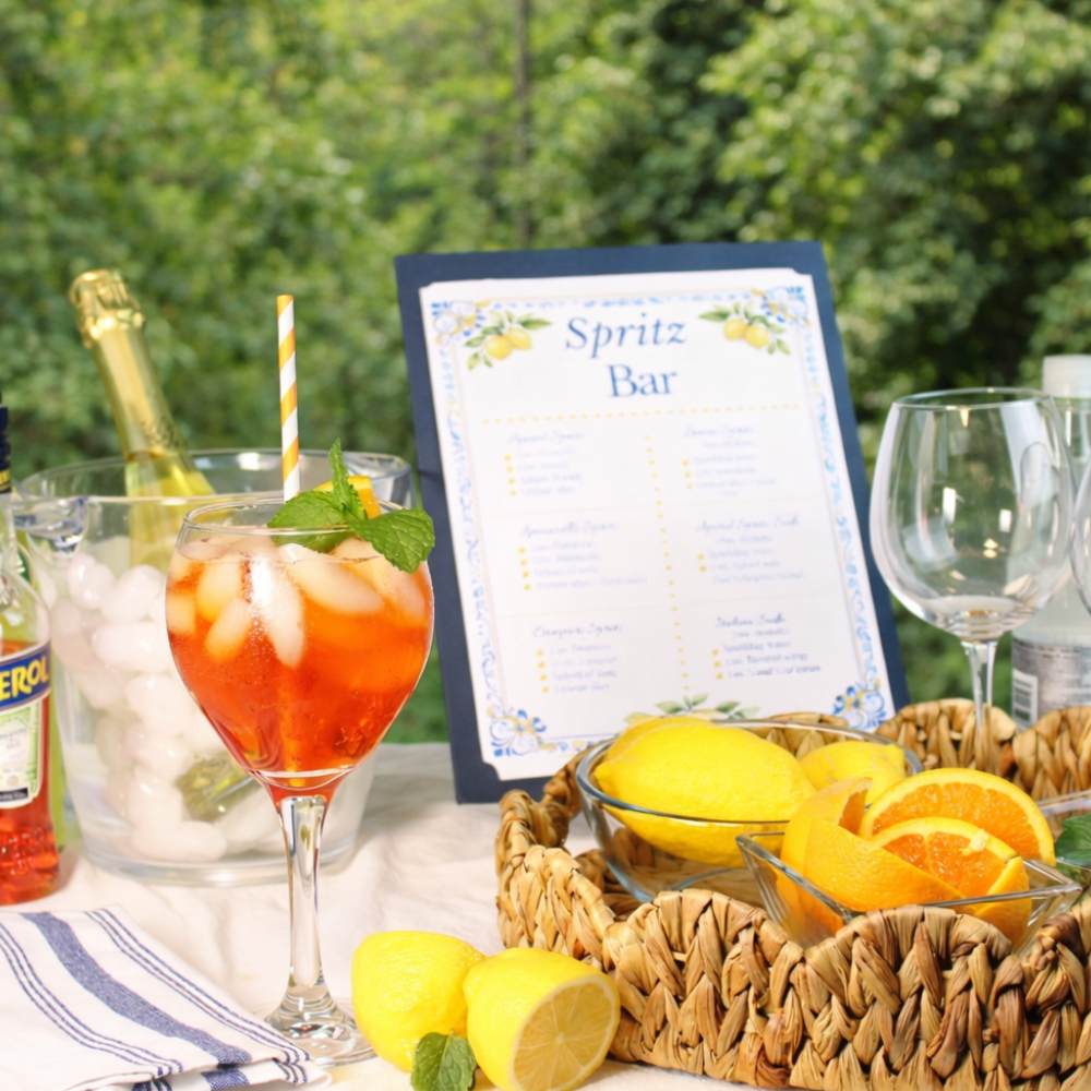Capri-inspired spritz bar setup with Aperol, limoncello, citrus garnishes, and summer entertaining decor