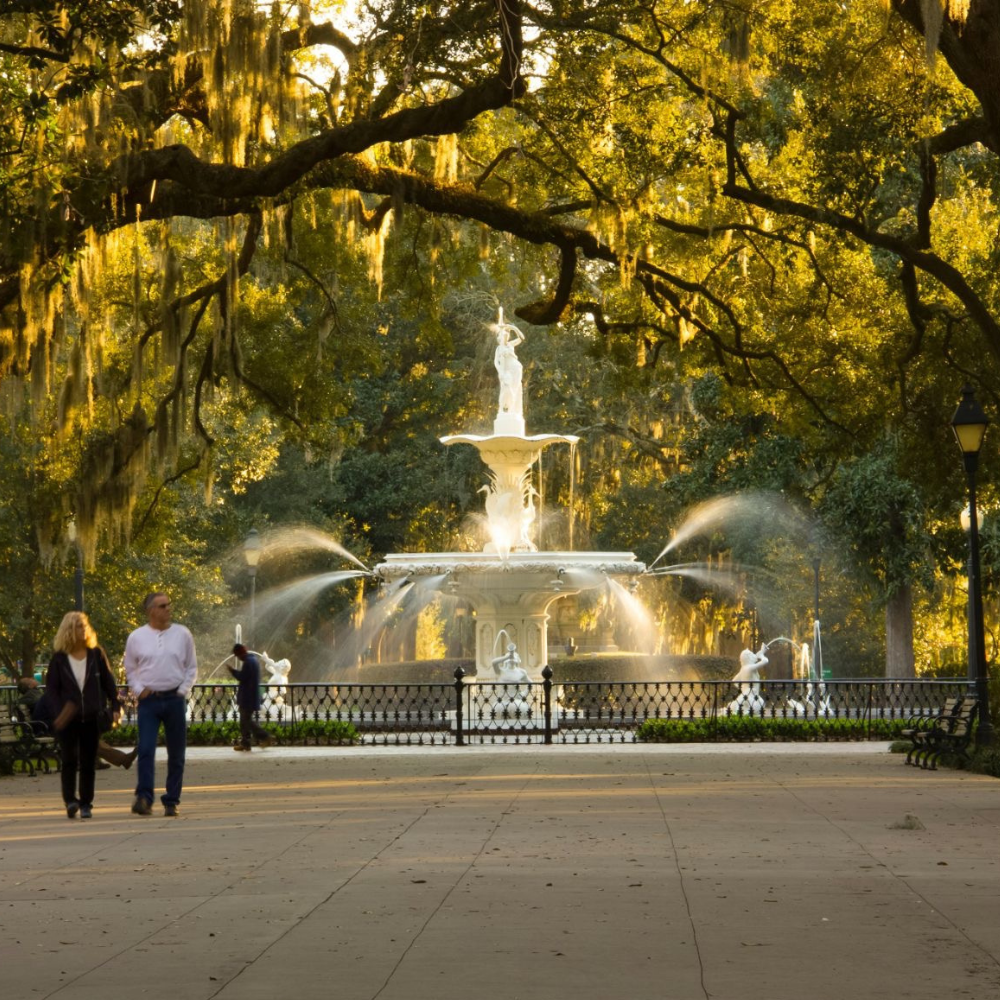Forsyth Park fountain in Savannah, Georgia surrounded by oak trees and Spanish moss