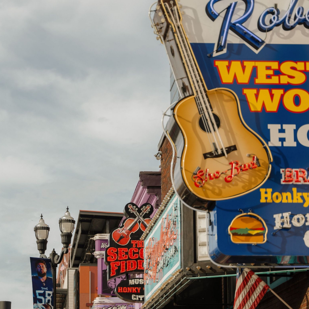 Neon guitar sign and downtown Nashville buildings in Music City, Tennessee
